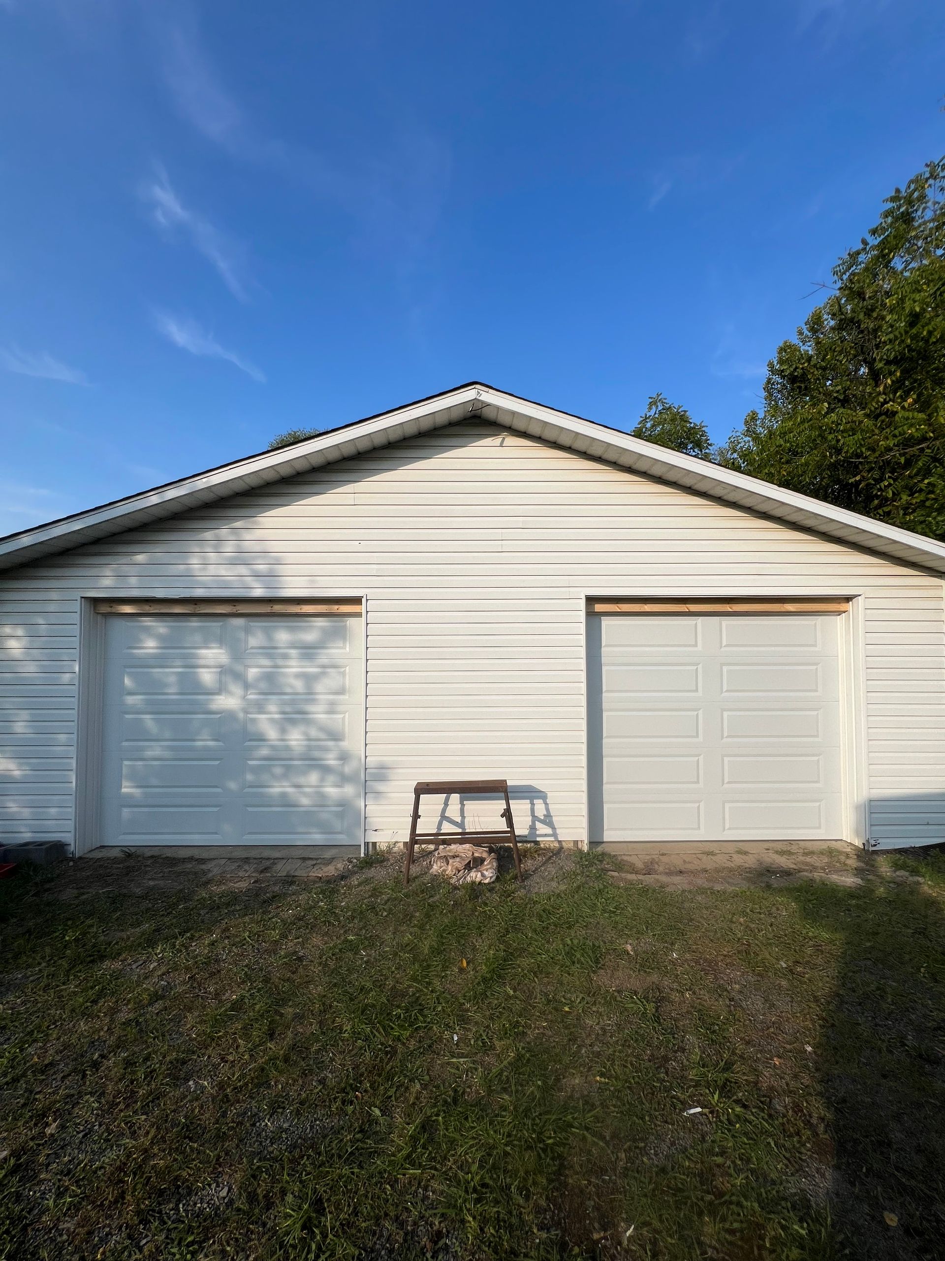 A white garage with a blue sky in the background