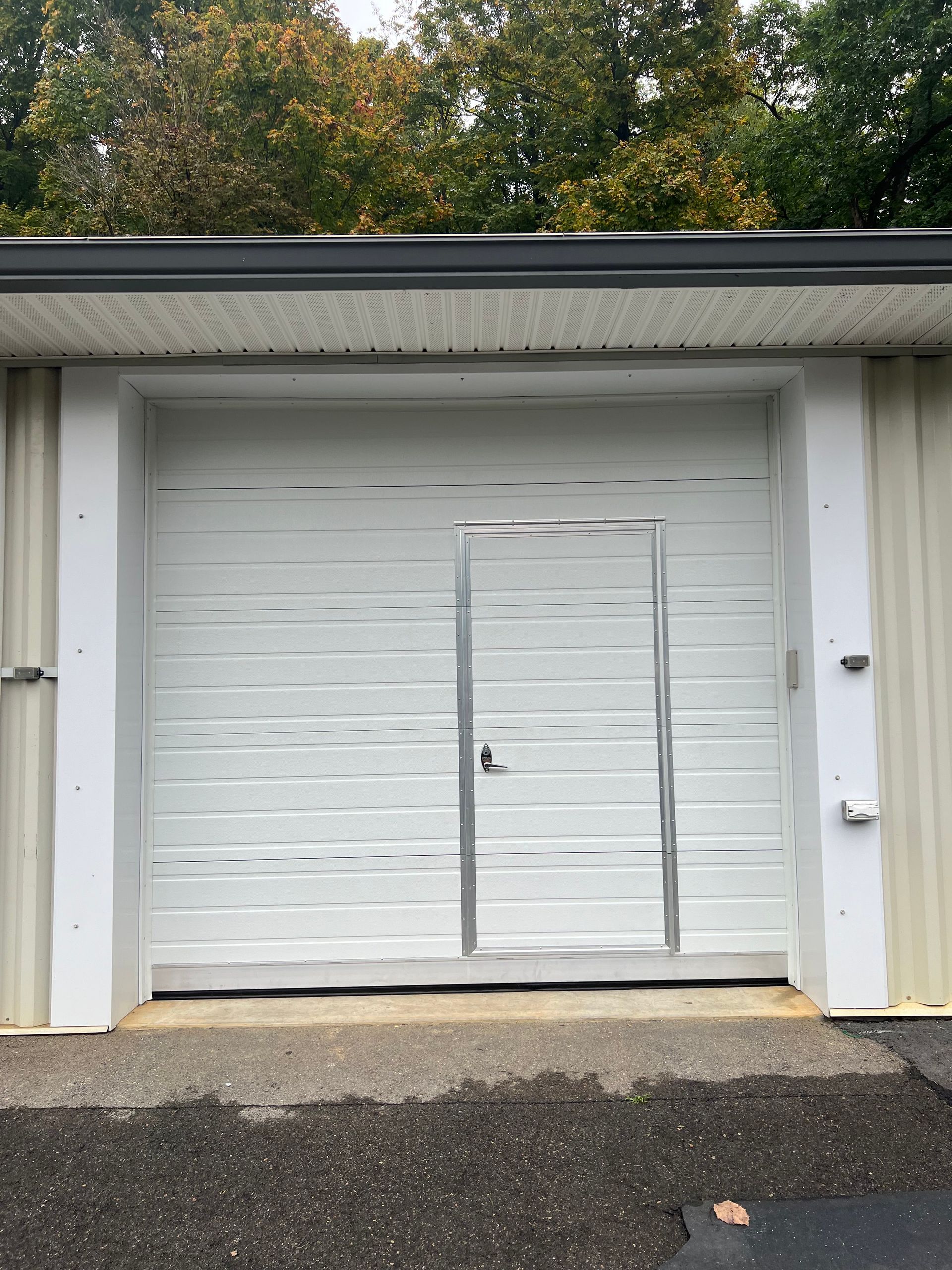 A white garage door with a door in it