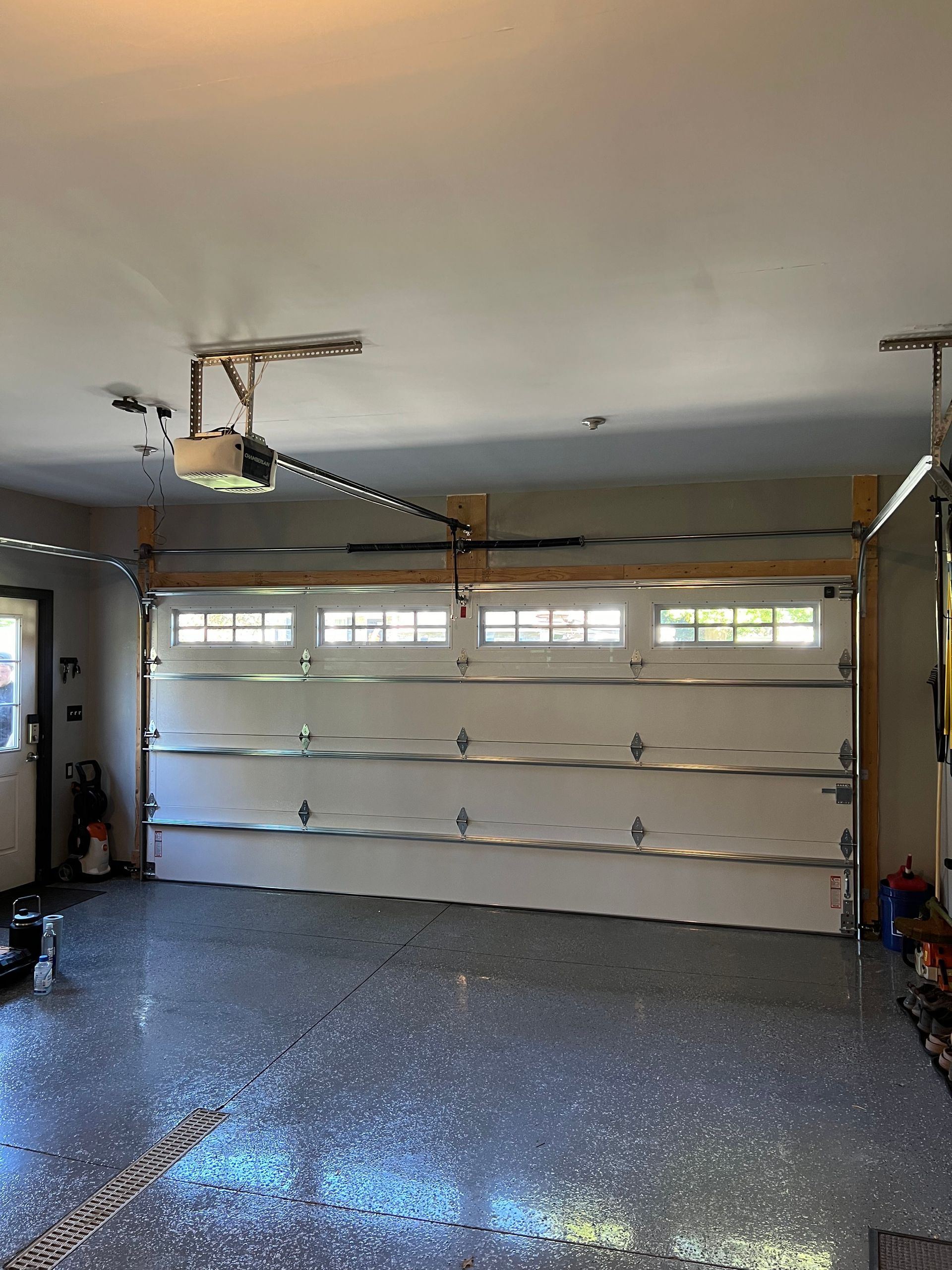 A garage with a garage door open and a garage door opener.