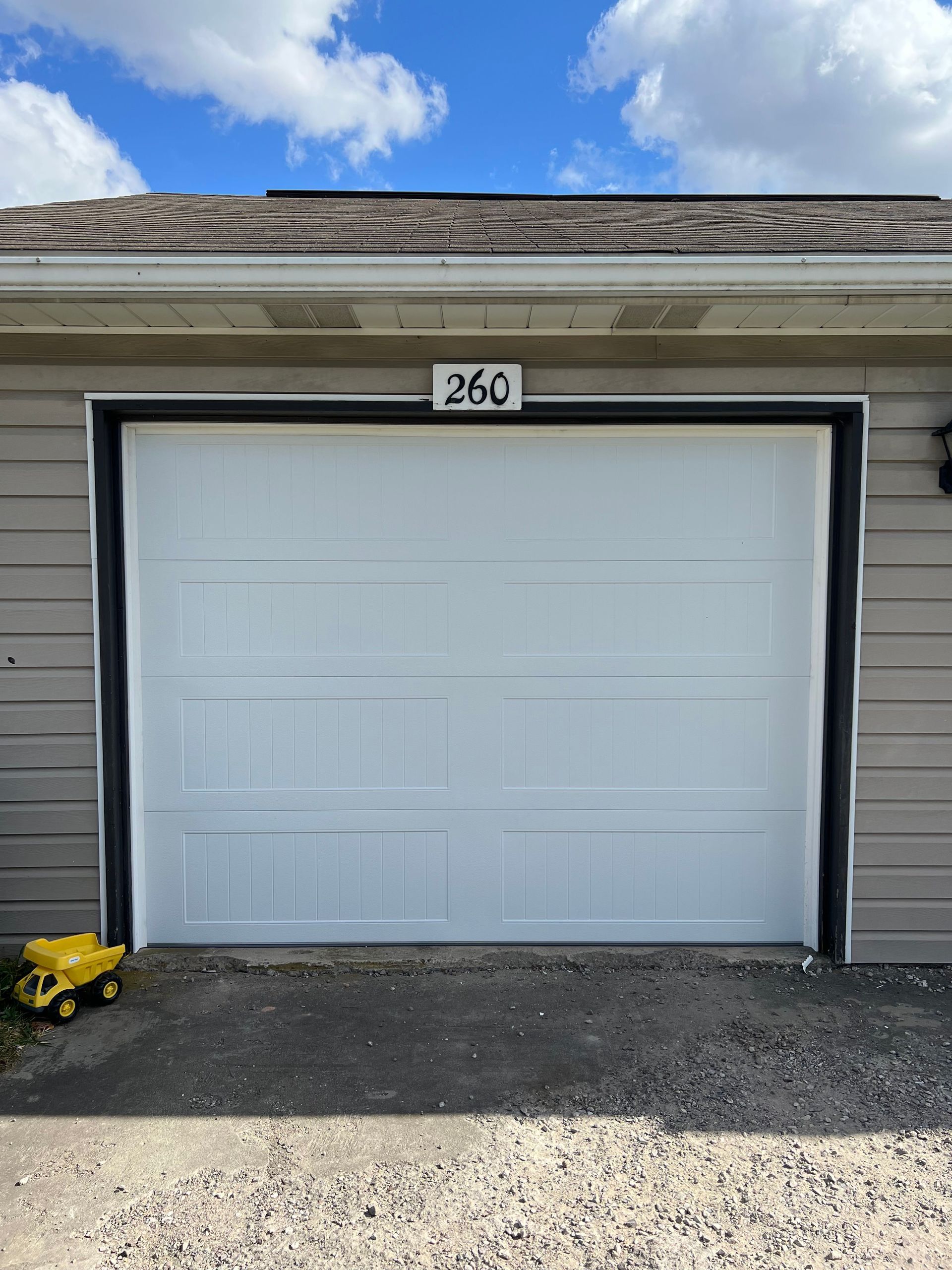 A white garage door with the number 36c on it