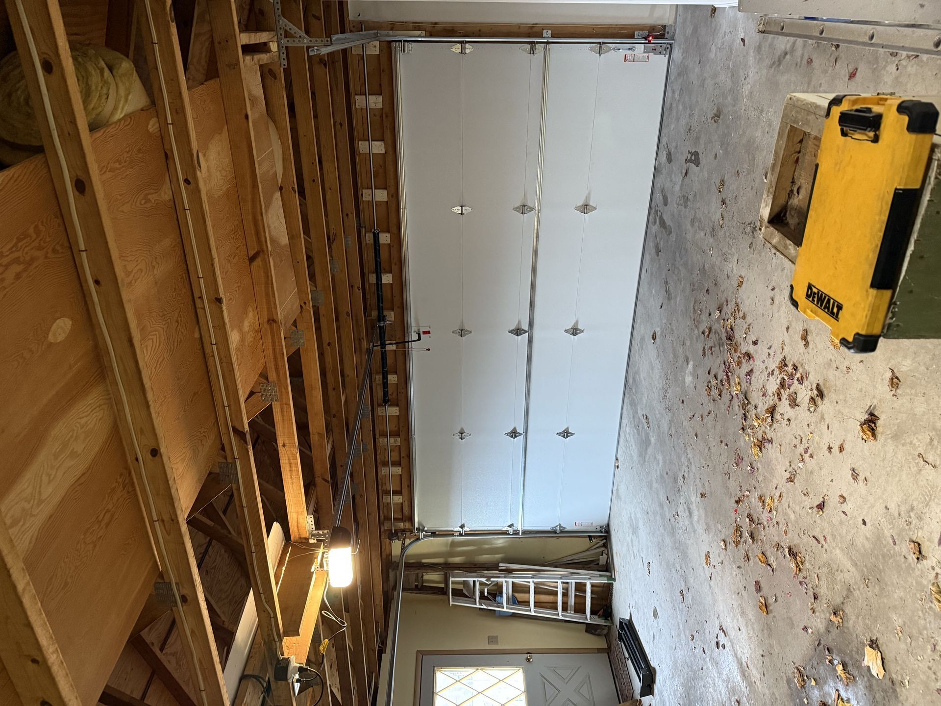 A garage with a garage door and a ladder in it