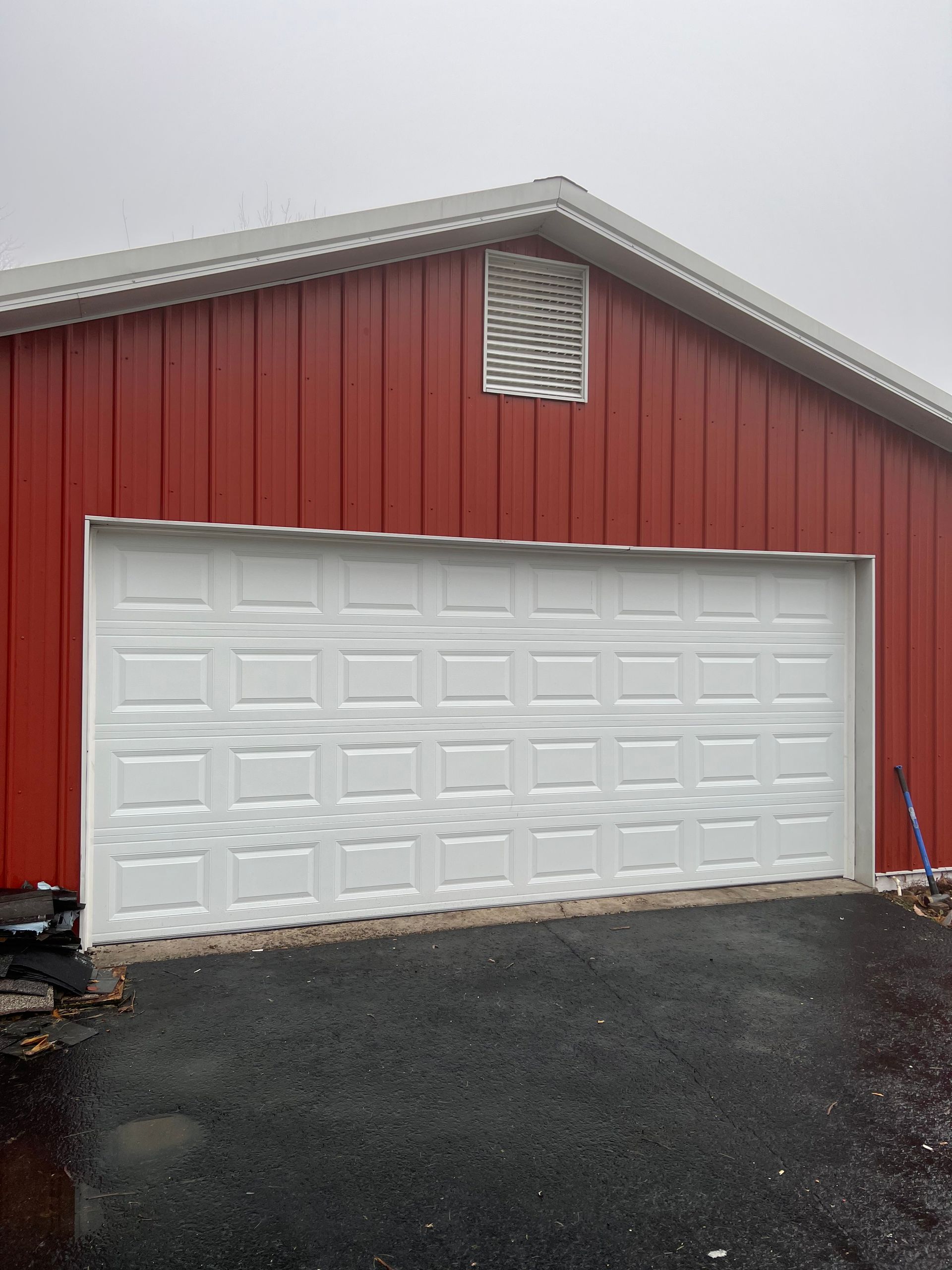 A red building with a white garage door