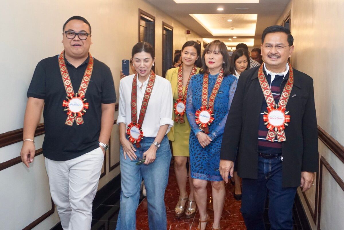 A group of people are walking down a hallway wearing medals.