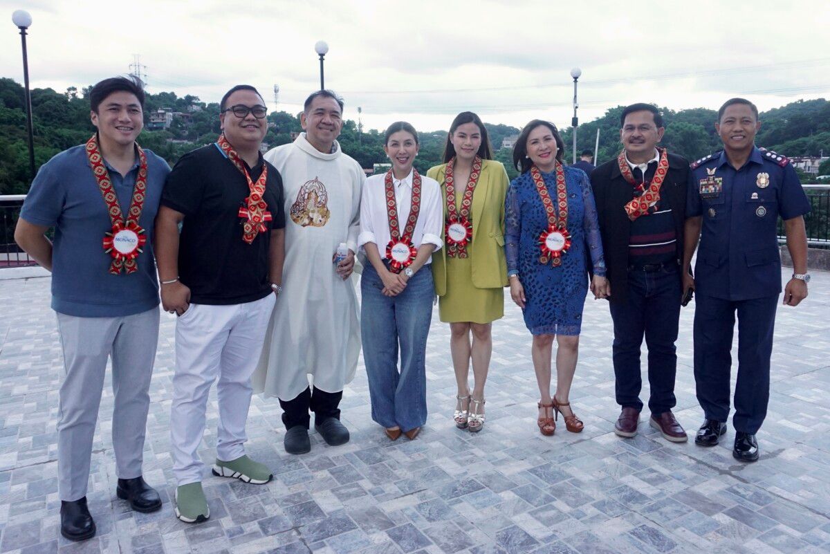 A group of people are standing next to each other on a rooftop.