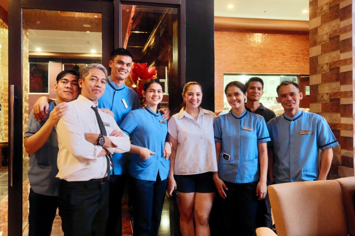 A group of people posing for a picture in a room.