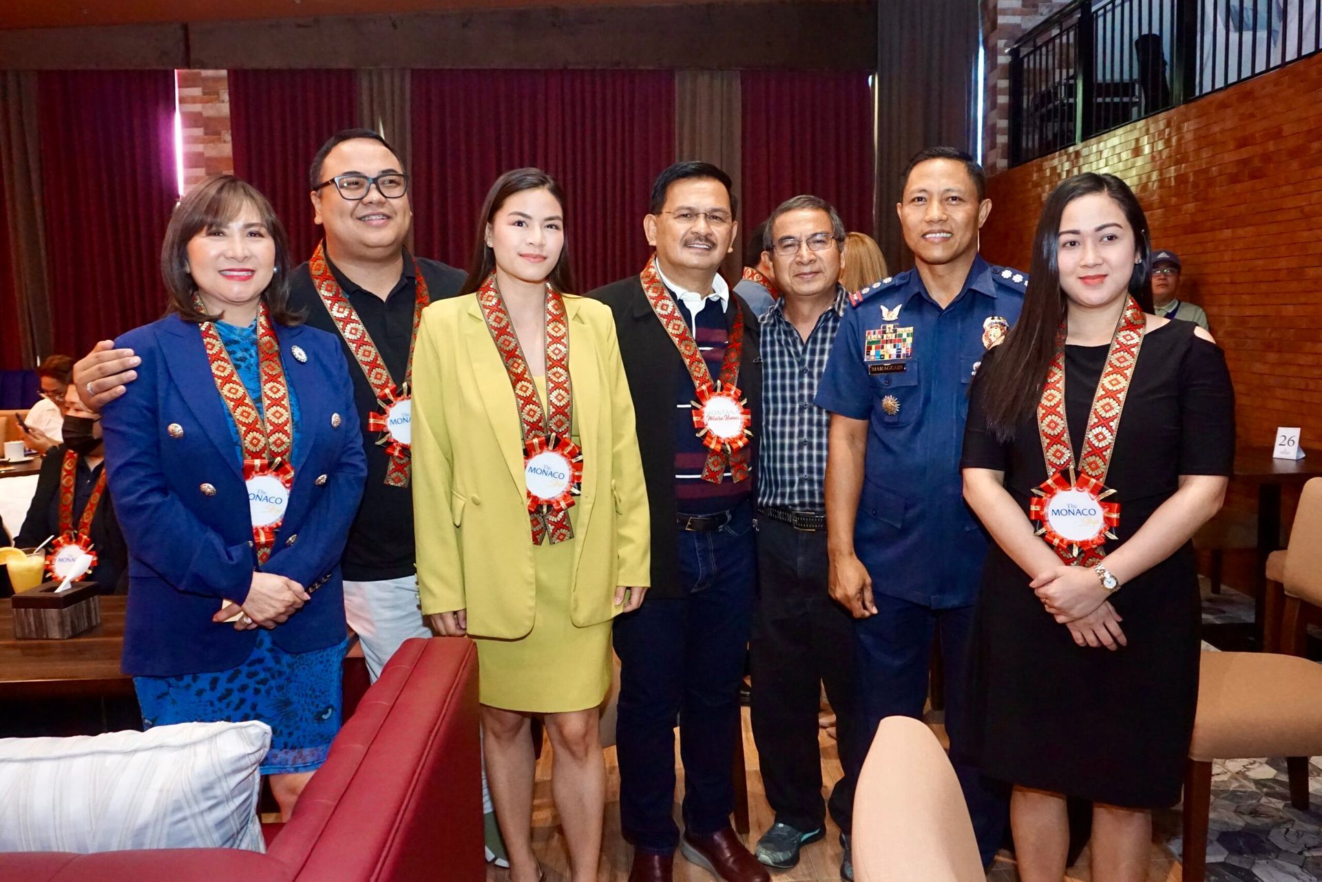 A group of people are posing for a picture together in a room.