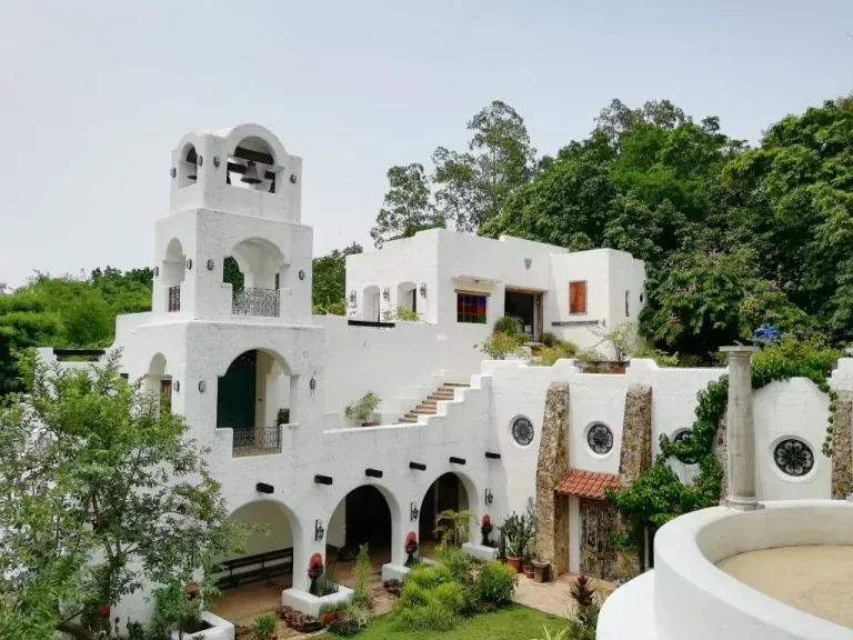 A large white building with a bell tower on top of it