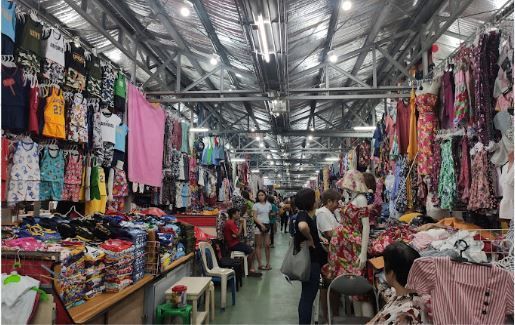 A market filled with lots of clothes and people.