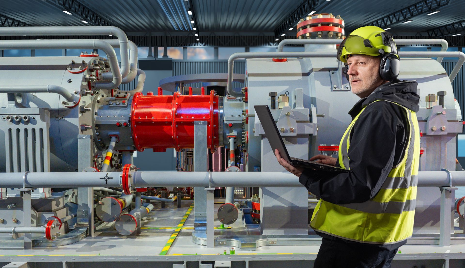 The technician tracks mechanical system performance using a laptop.