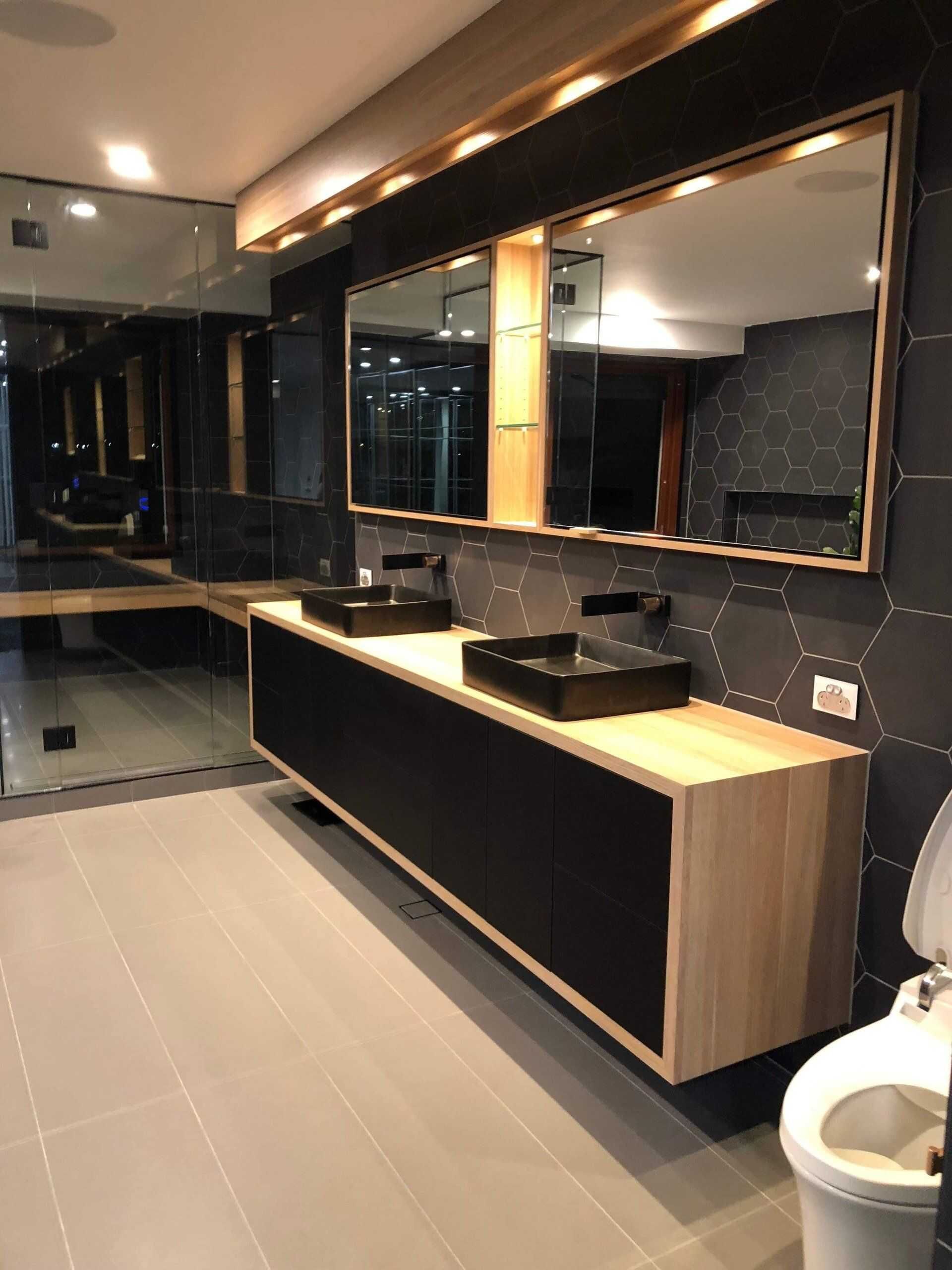 A Bathroom With a Toilet and a Mirror — Michael Duncan Constructions Pty Ltd in Robina, QLD