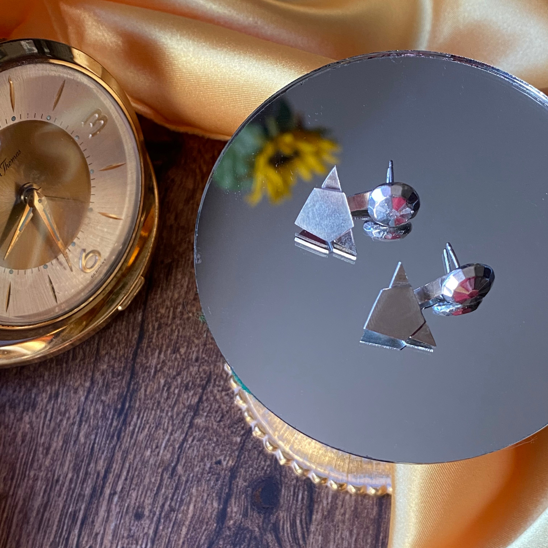 Wild Sunflower Silver Handmade Jewelry geometric earrings, on gold fabric.