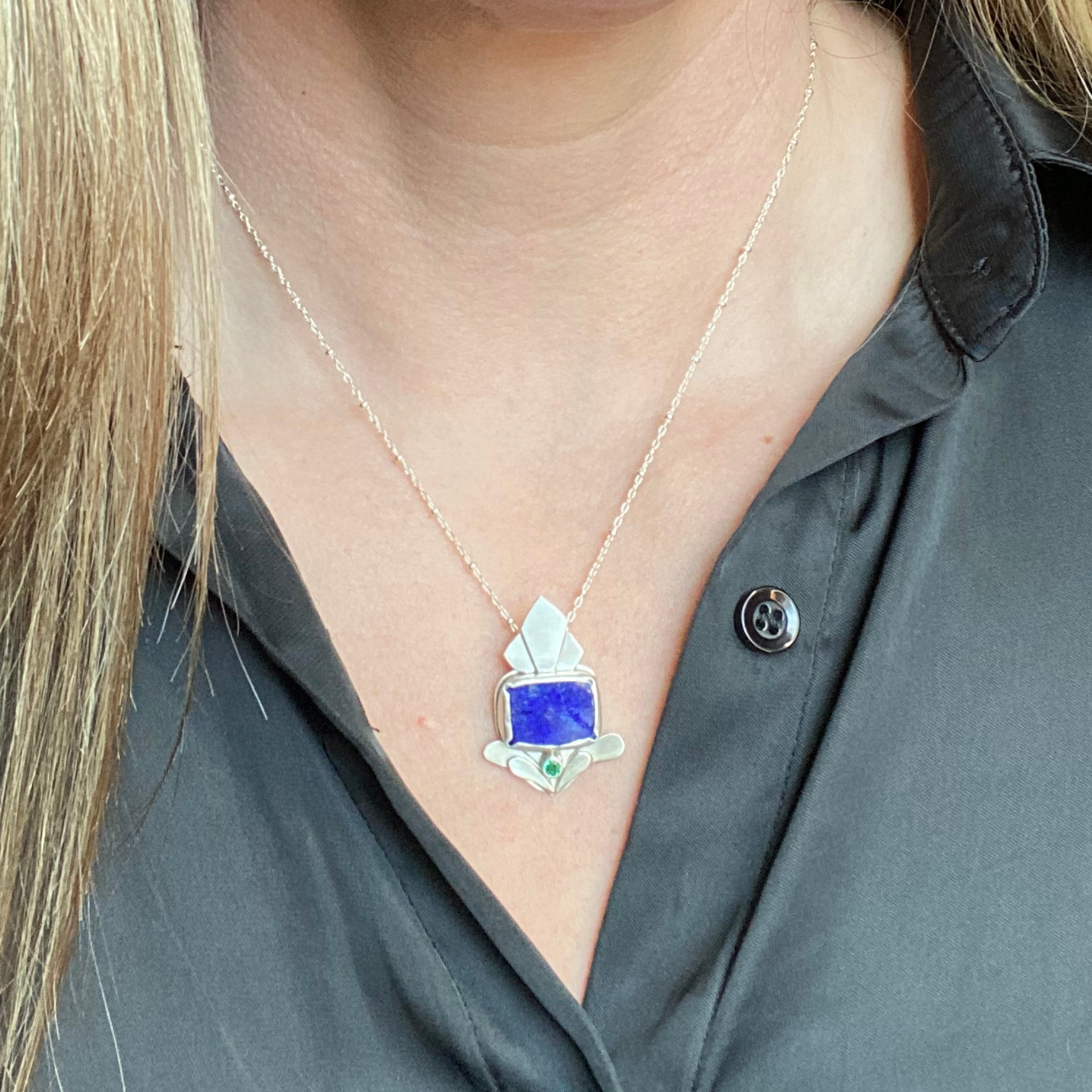 Silver pendant with a blue rectangular stone and an emerald, on a silver chain. Wild Sunflower Silver Handmade Jewelry