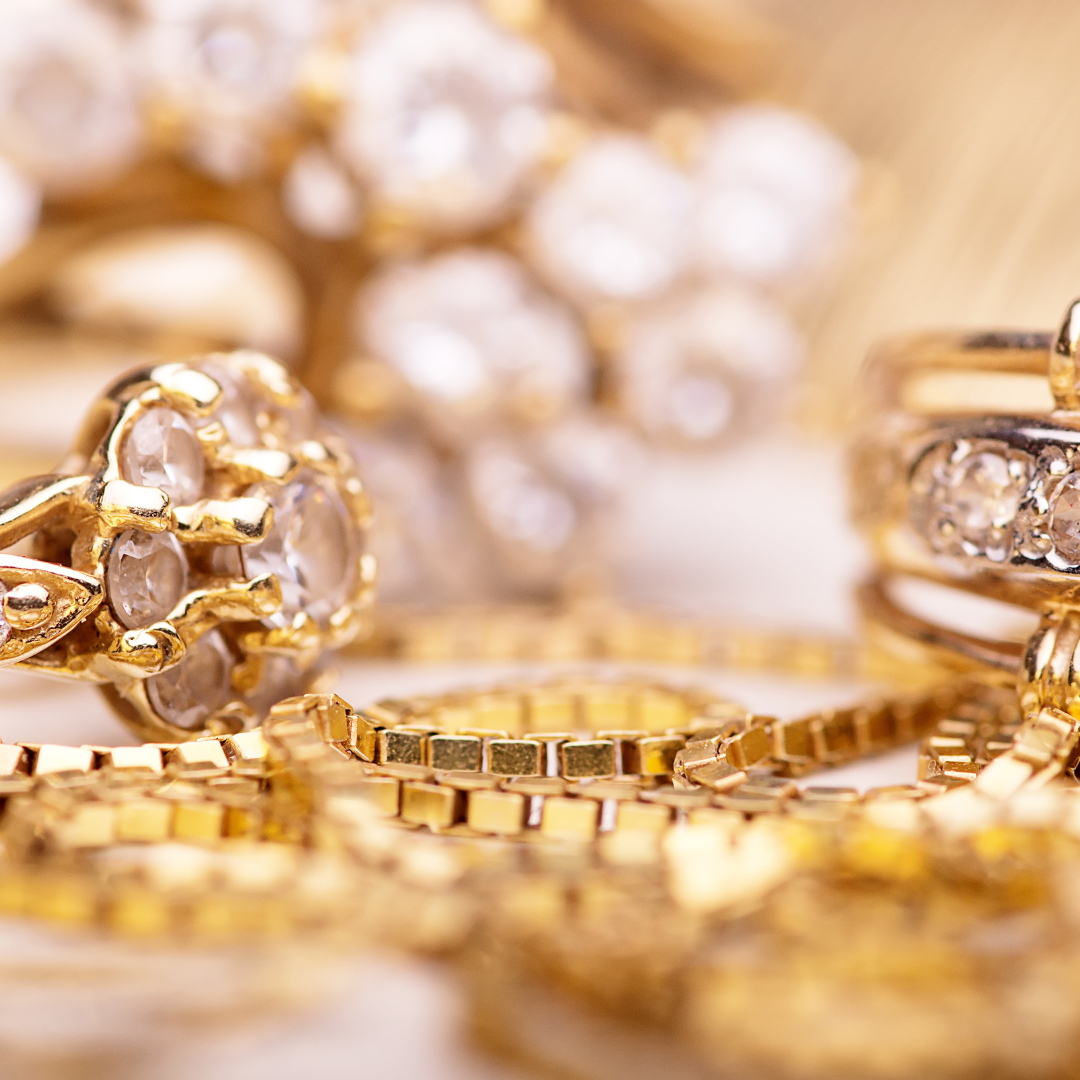 A close up of a bunch of gold jewelry on a table.