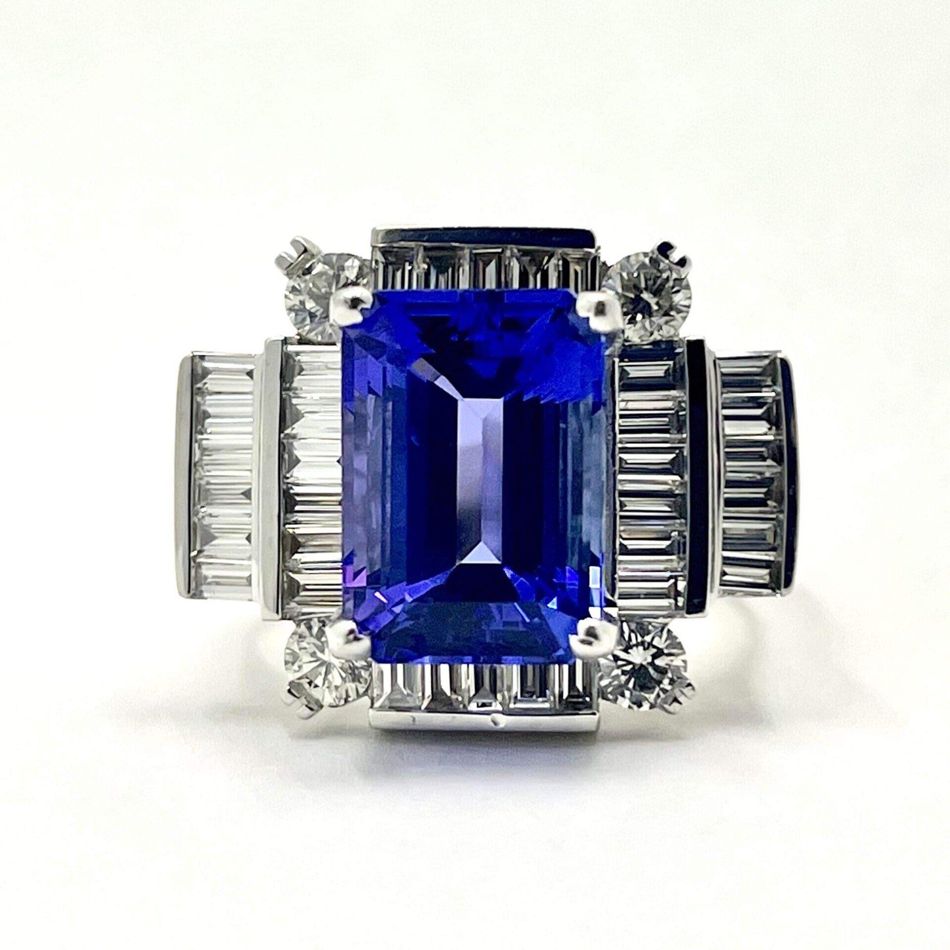 A ring with an emerald cut sapphire and baguette diamonds
