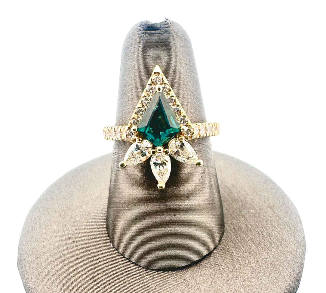 A ring with a green stone and diamonds on a ring holder