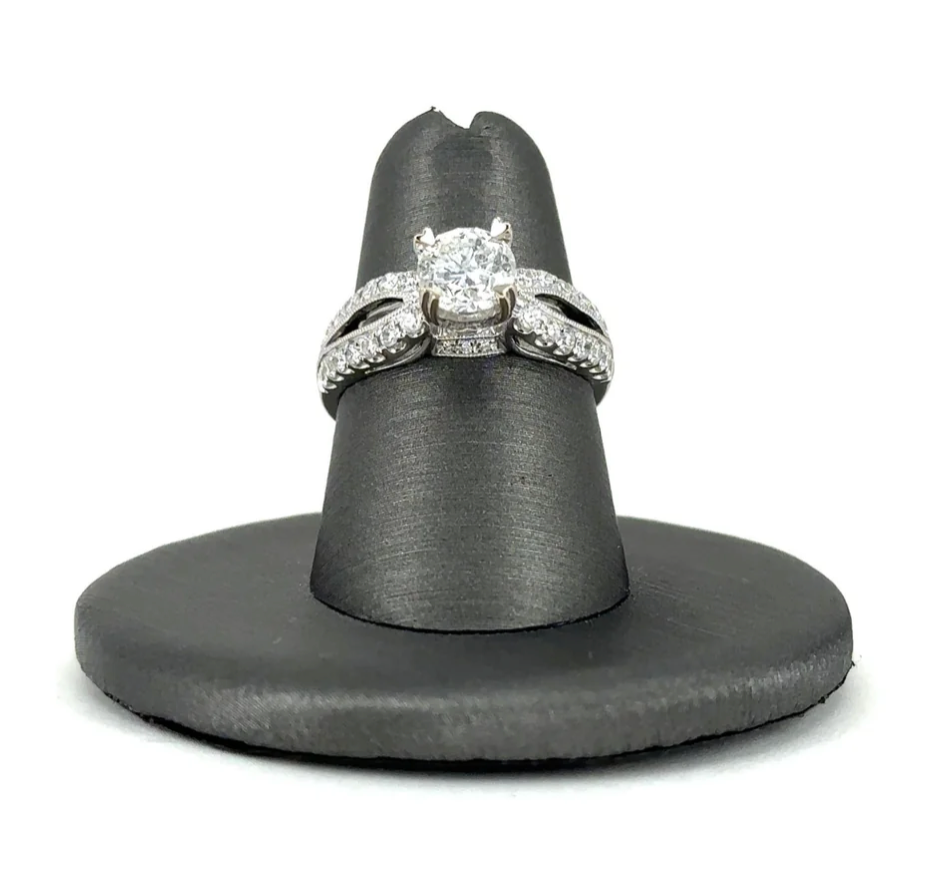 A diamond ring is sitting on a black ring holder