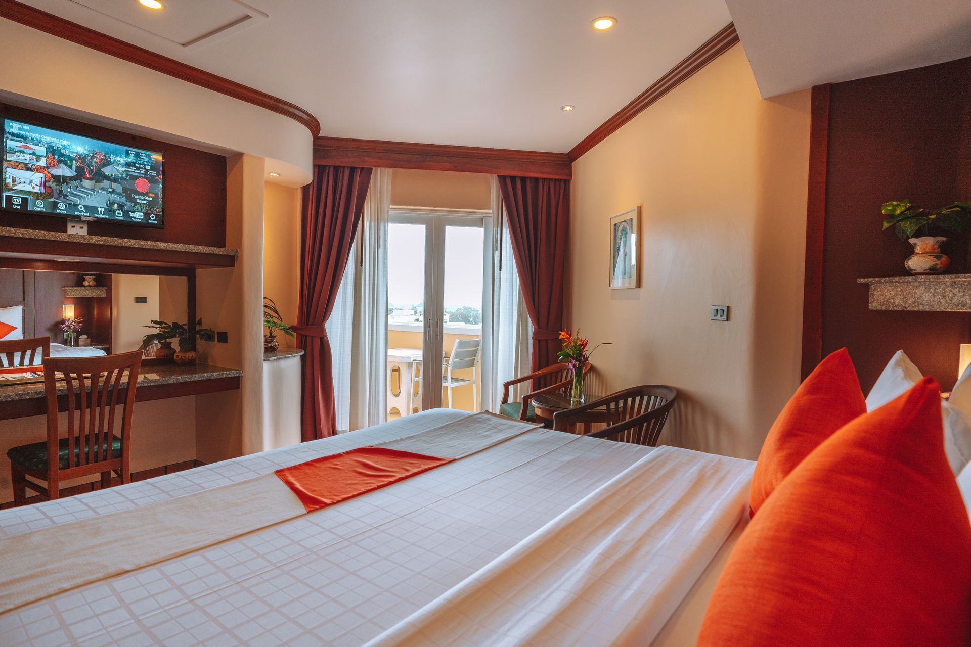 A hotel room with a large bed and a flat screen tv