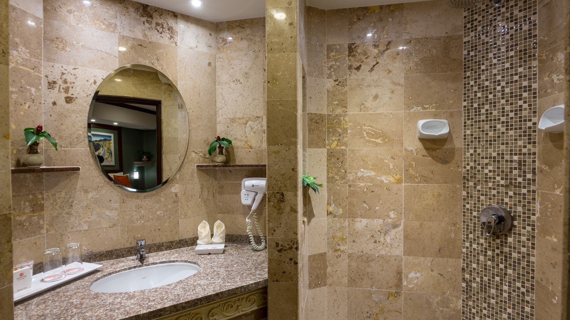 A bathroom with a sink , mirror , and shower.