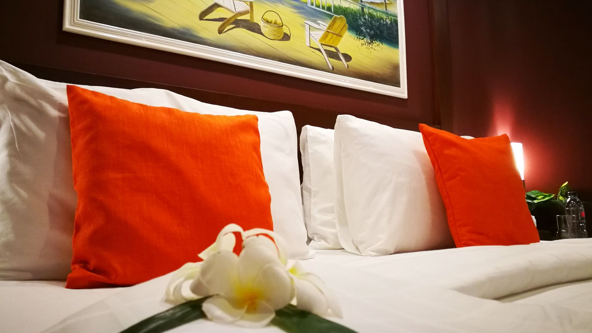 A hotel room with a sliding glass door leading to a balcony with a table and chairs.
