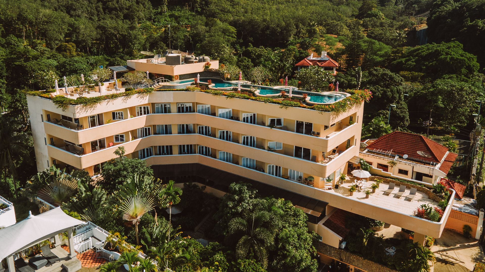An aerial view of a large building surrounded by trees.