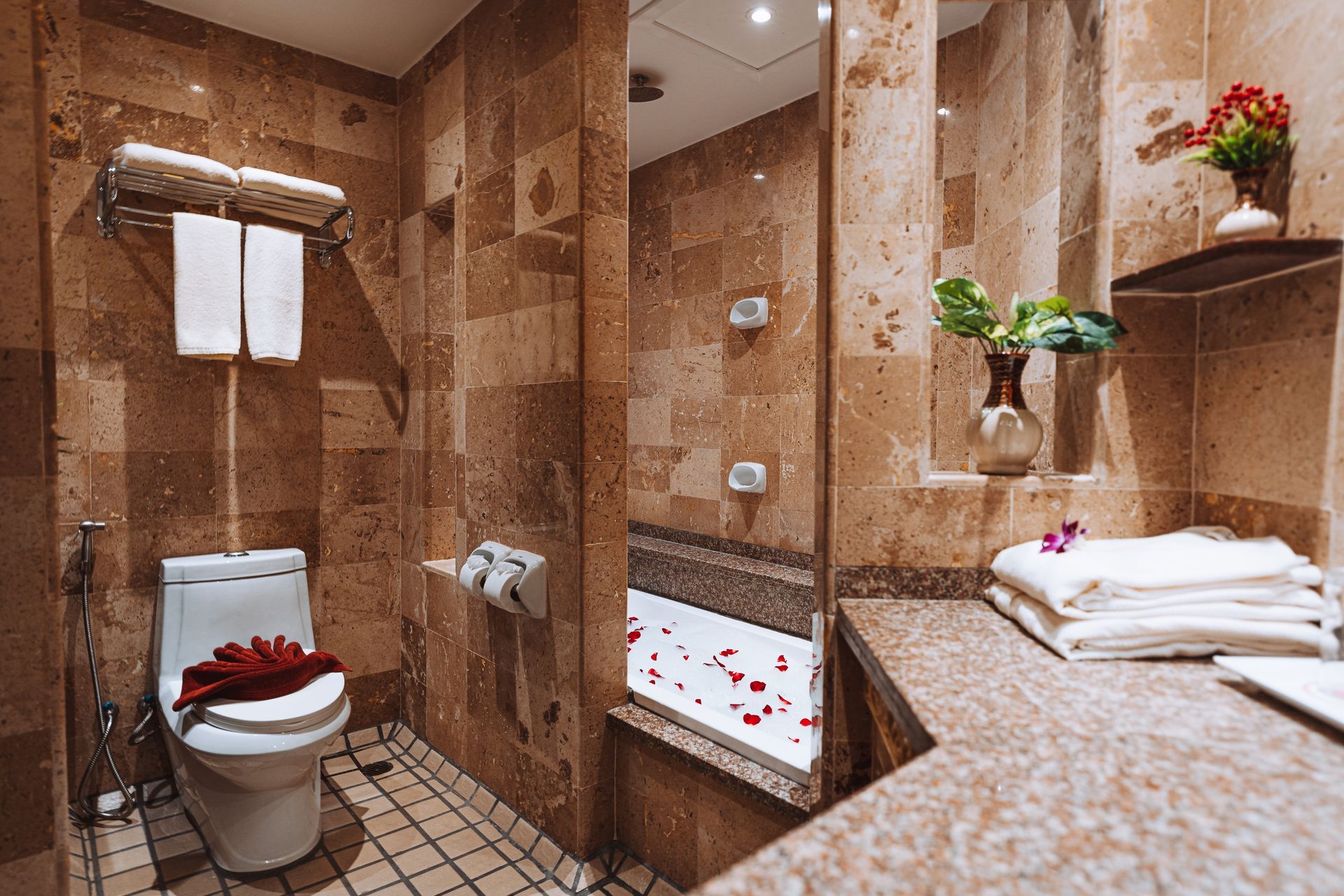 A hotel room with a bed , desk and television