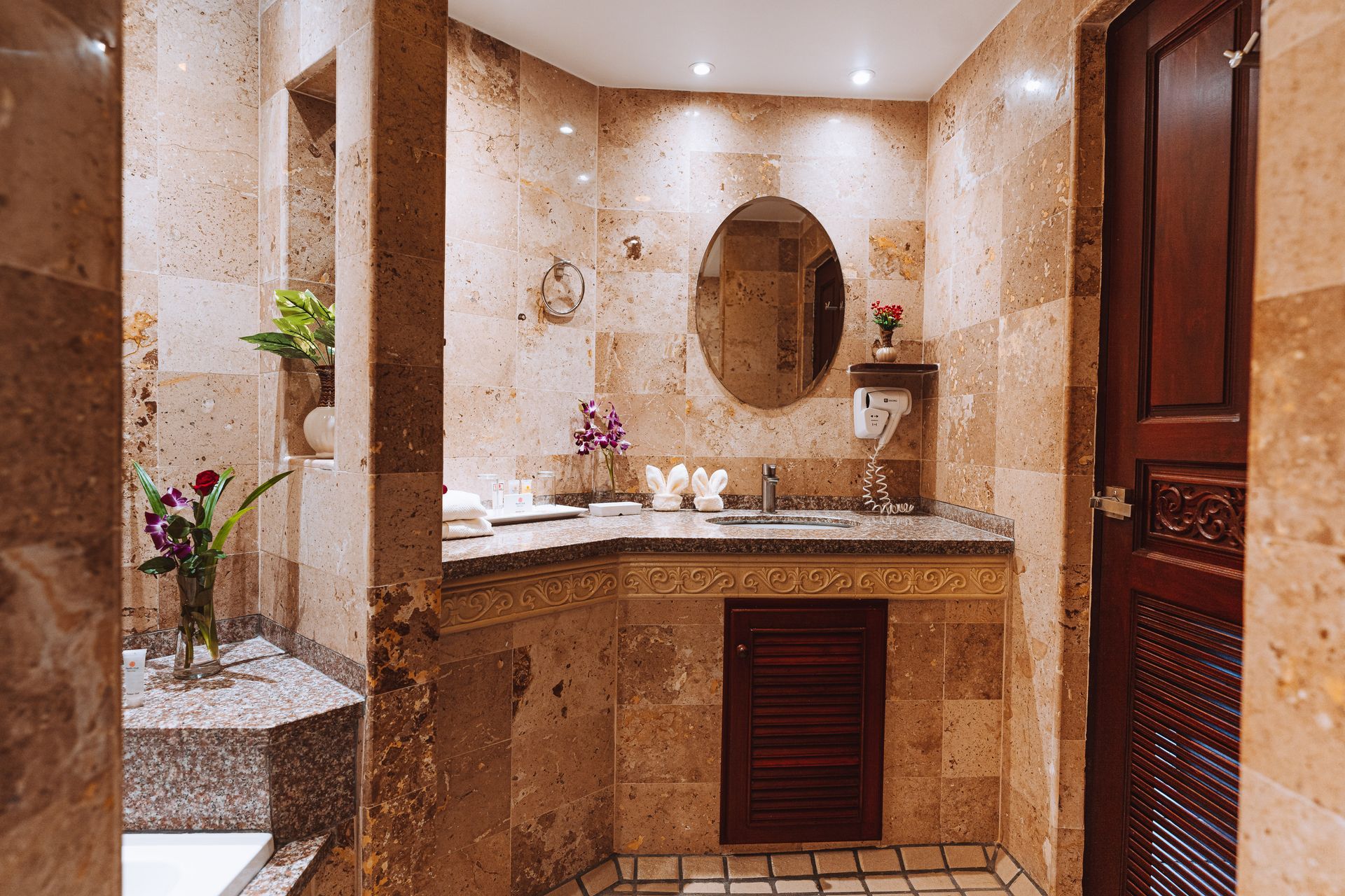 A bathroom with a sink , mirror , and walk in shower.