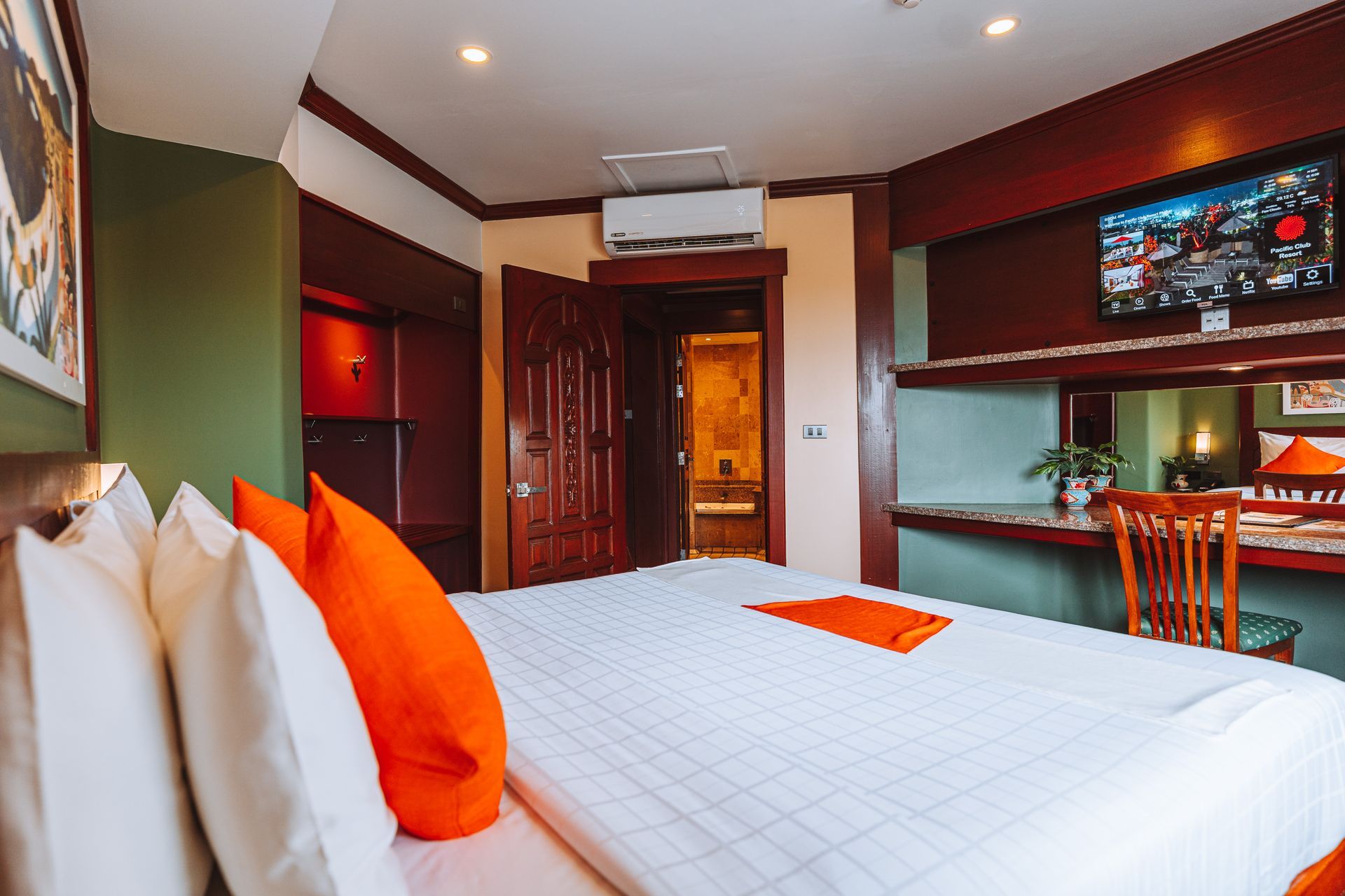 A living room with a couch and a potted plant