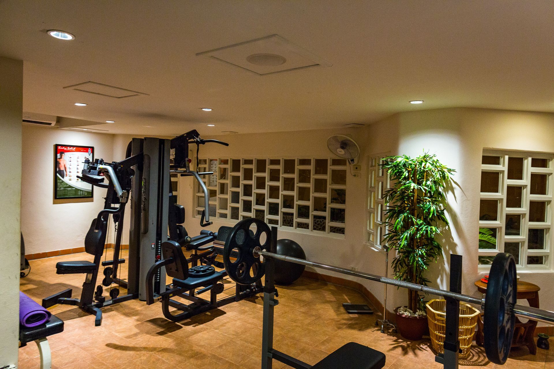 A gym with a barbell in the middle of it