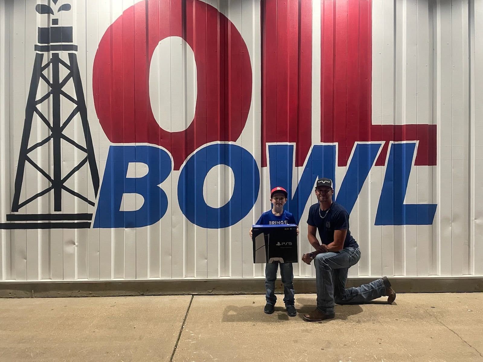 Man and child pose in front of a white wall with
