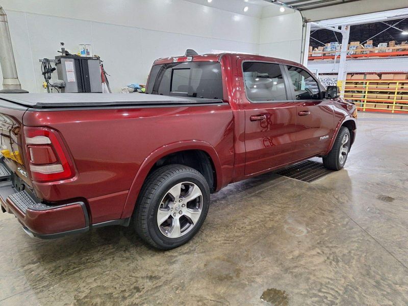 A red dodge ram truck is parked in a garage.