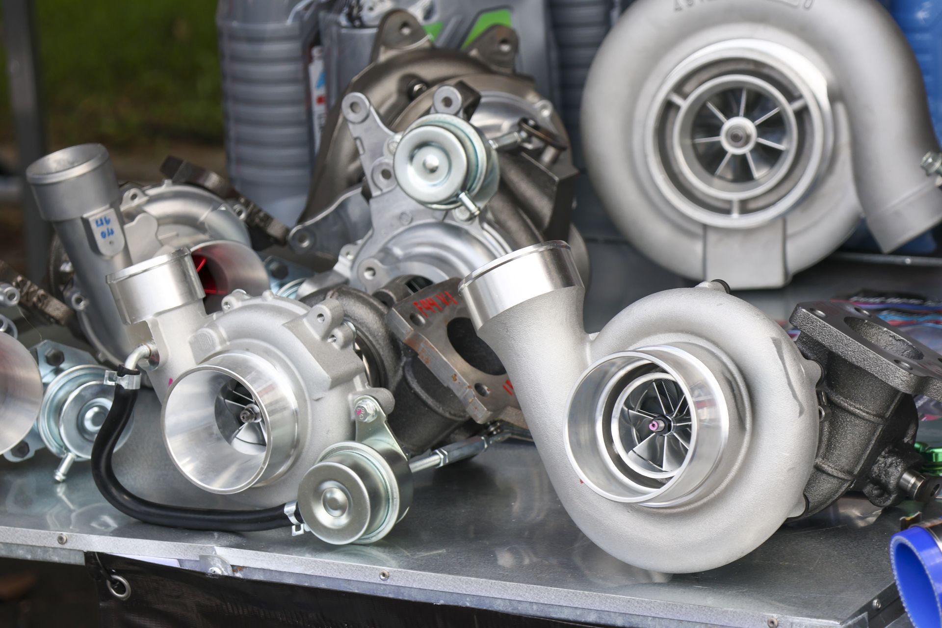Several silver turbochargers, displayed on a table.