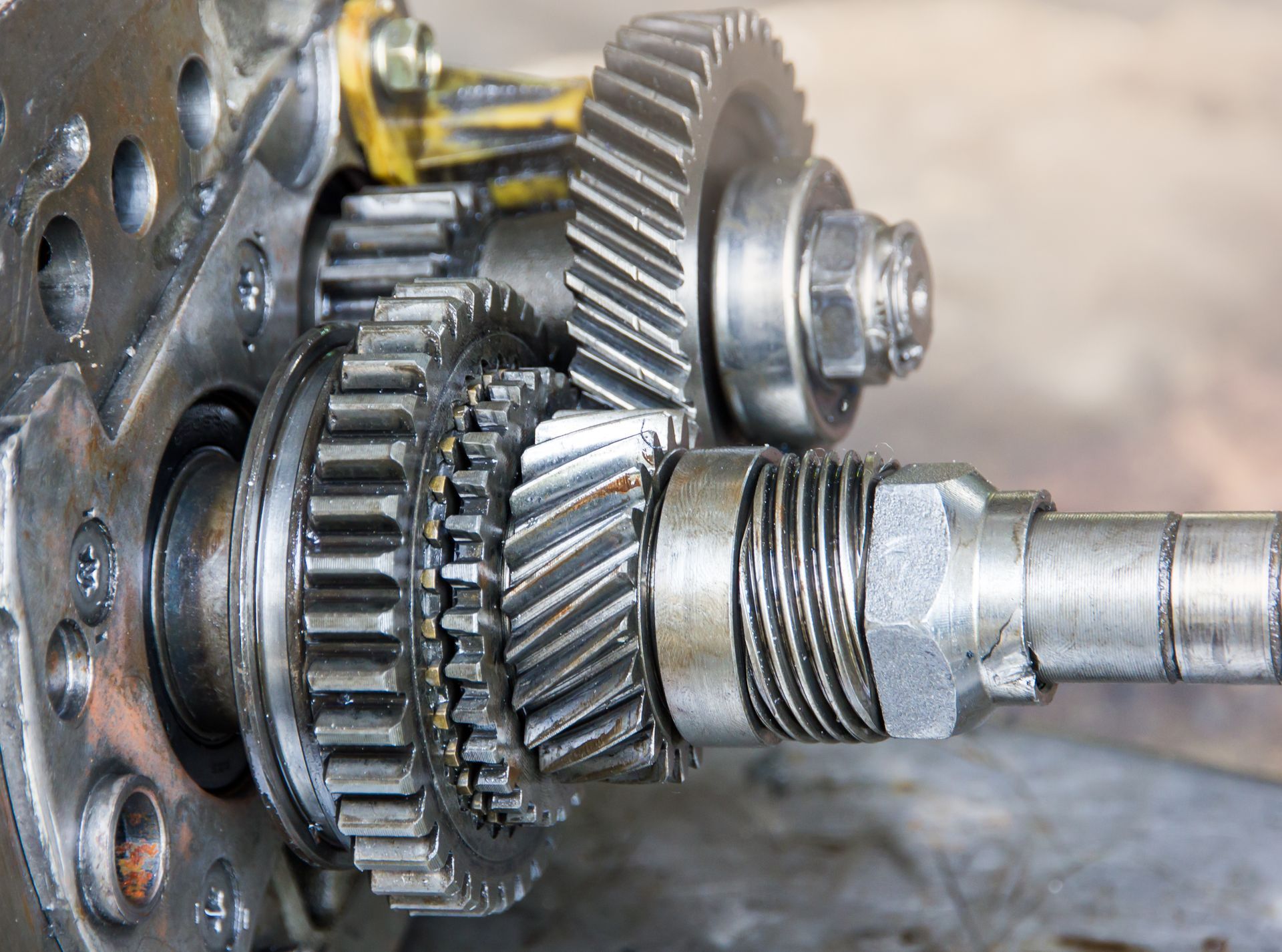 Gears meshing together inside a mechanical device, visible metal components.