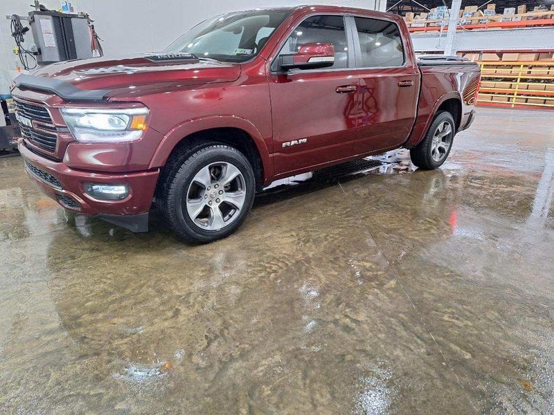 A red ram 1500 truck is parked in a warehouse.
