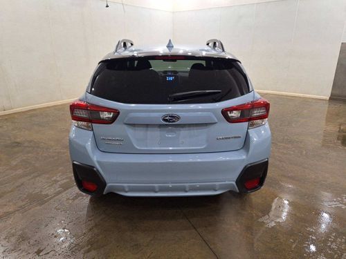 The rear end of a subaru xv is shown in a showroom.