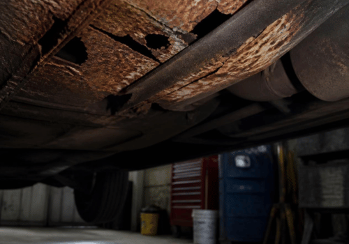 Close-up of severe rust and corrosion on the underside of a vehicle