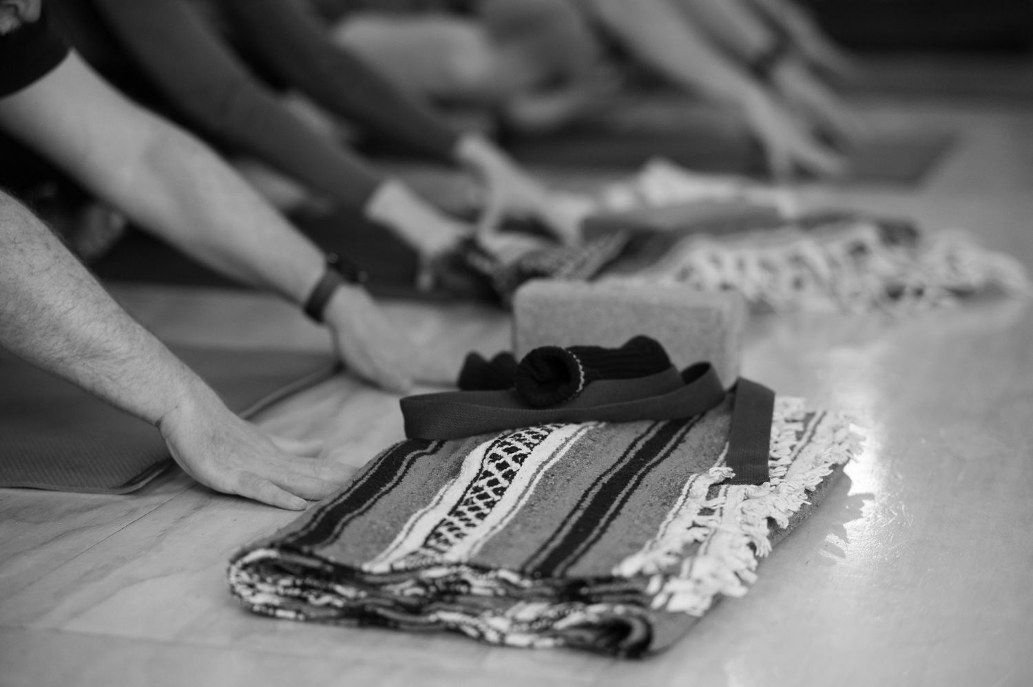 A woman is doing yoga in front of a mirror in a black and white photo.