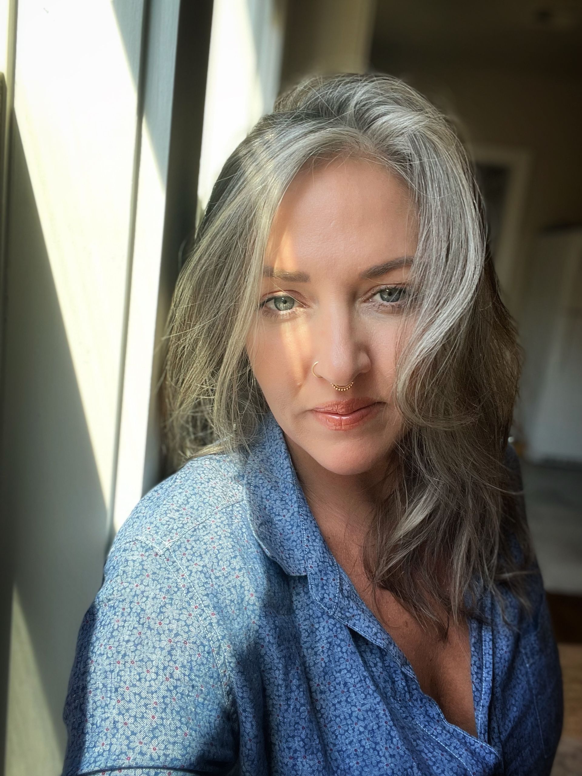 A woman is doing a yoga pose on a rock.