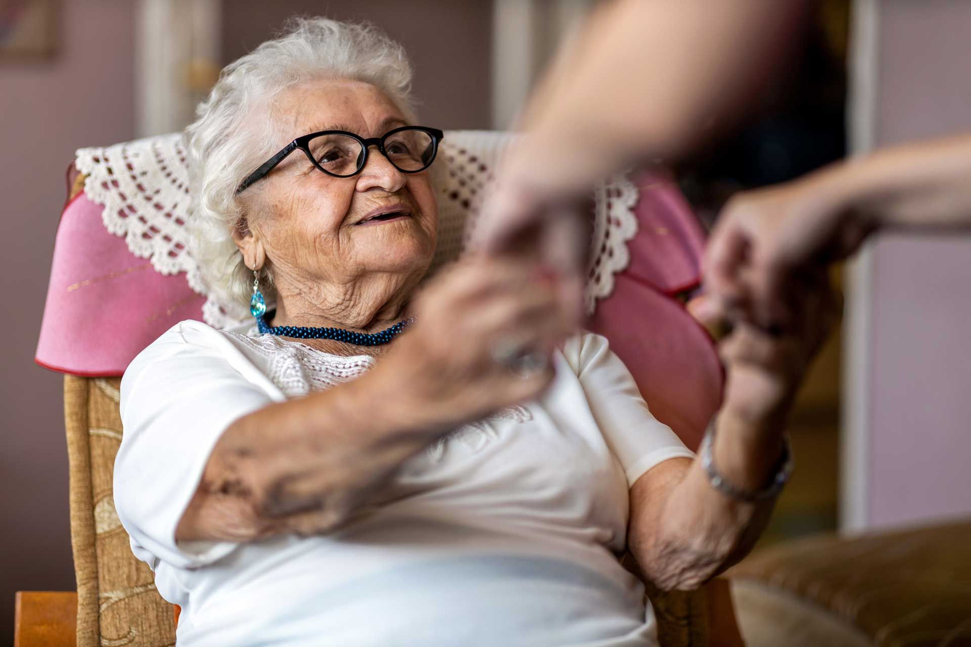 Person sitting in a chair holding a card Person sitting in a chair holding a card