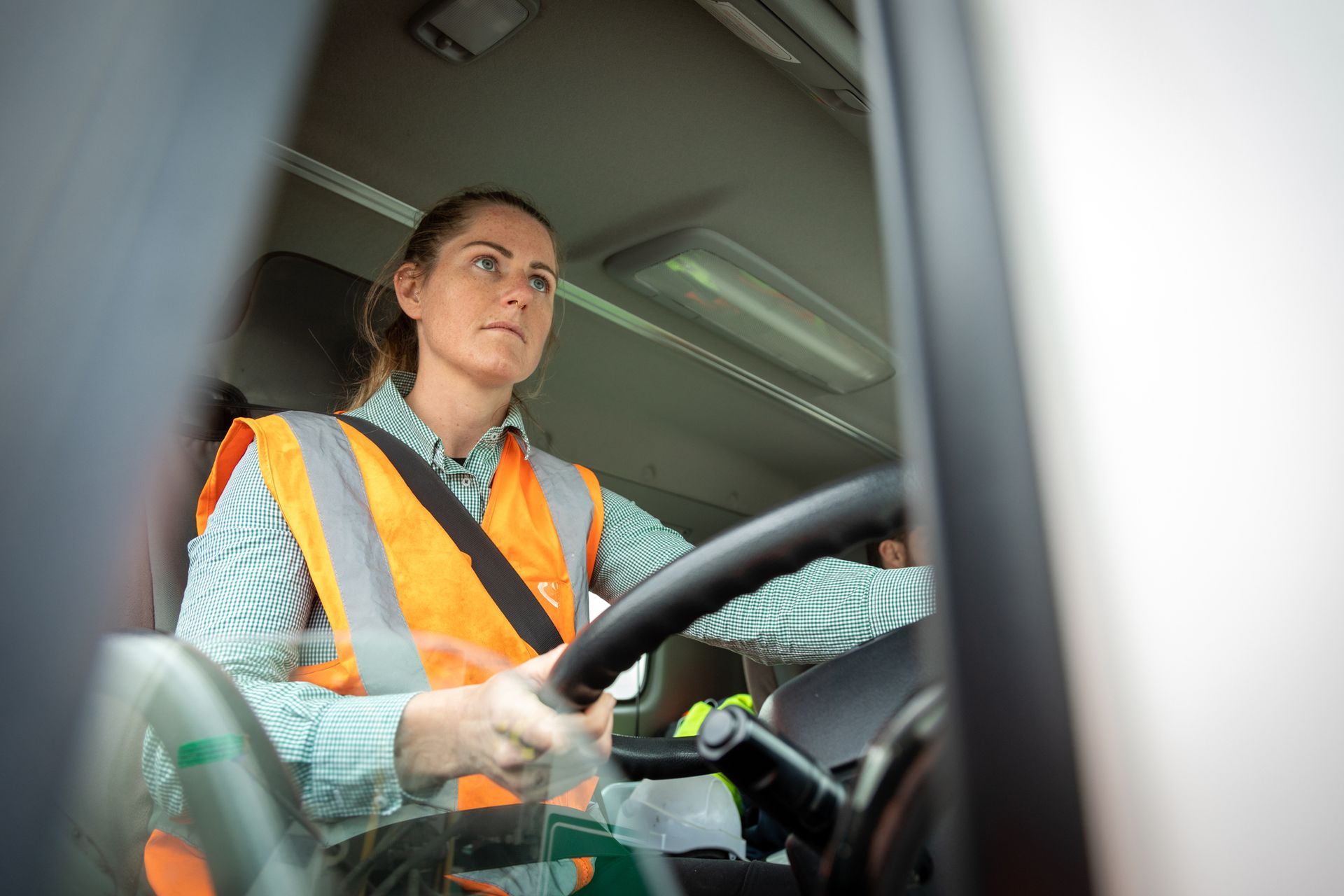 A woman is driving a vehicle. A woman is driving a vehicle.