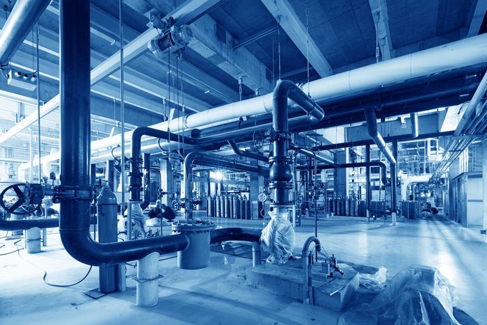 A factory filled with lots of pipes and machinery.