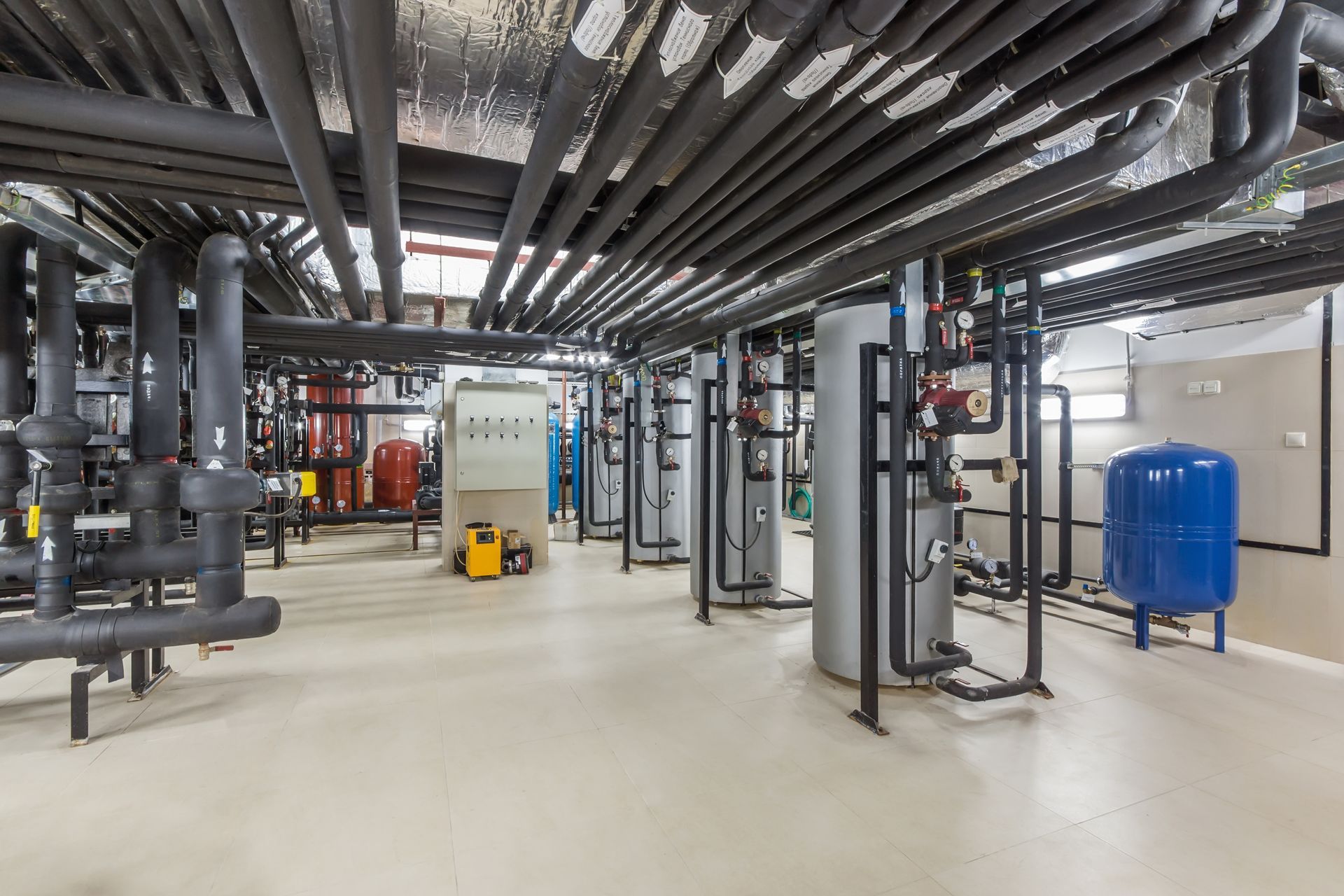 There are a lot of pipes and tanks in this room.