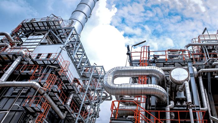 A large industrial plant with lots of pipes and stairs.