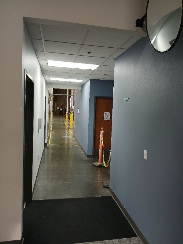 A long hallway with a mirror on the wall