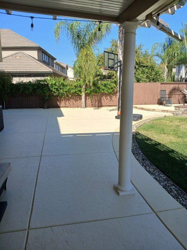 A patio with a basketball hoop in the backyard