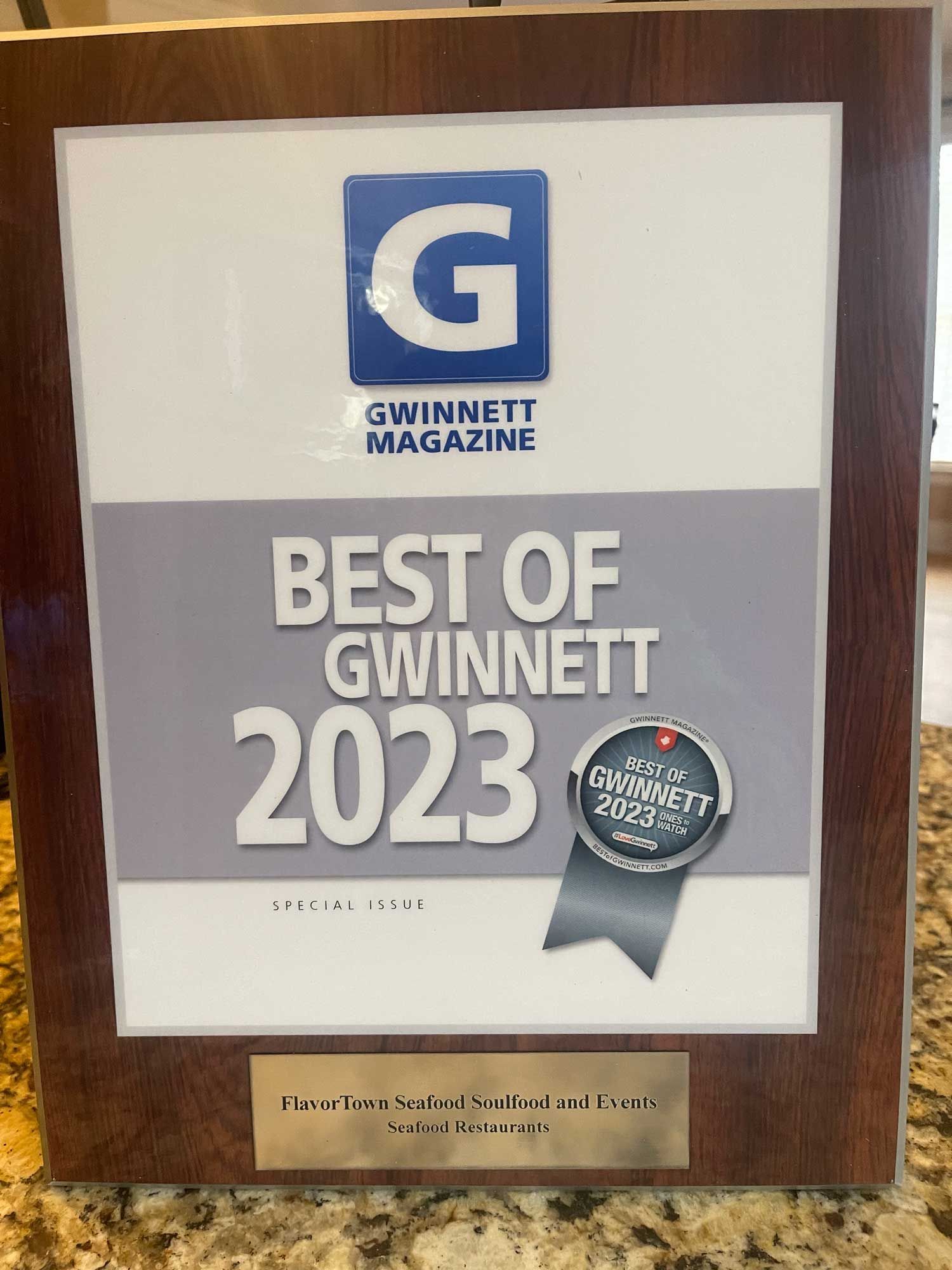 A wooden plaque that says best of gwinnett 2023