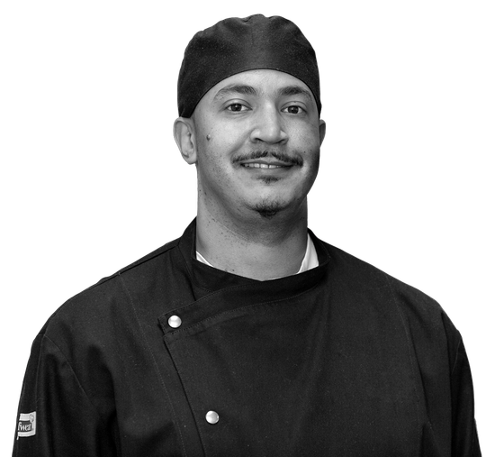 A black and white photo of a chef Bullard wearing a hat