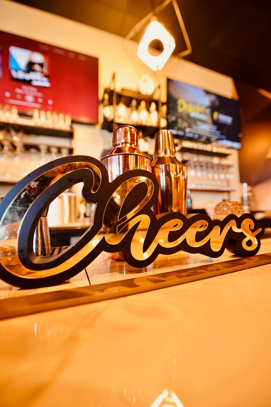 A bar with a sign that says cheers on it.