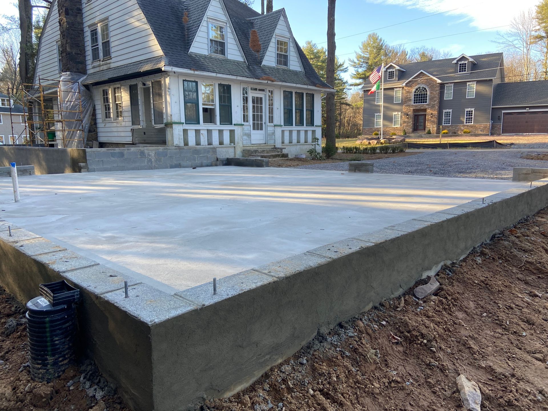A person is using a trowel to spread concrete on a sidewalk.