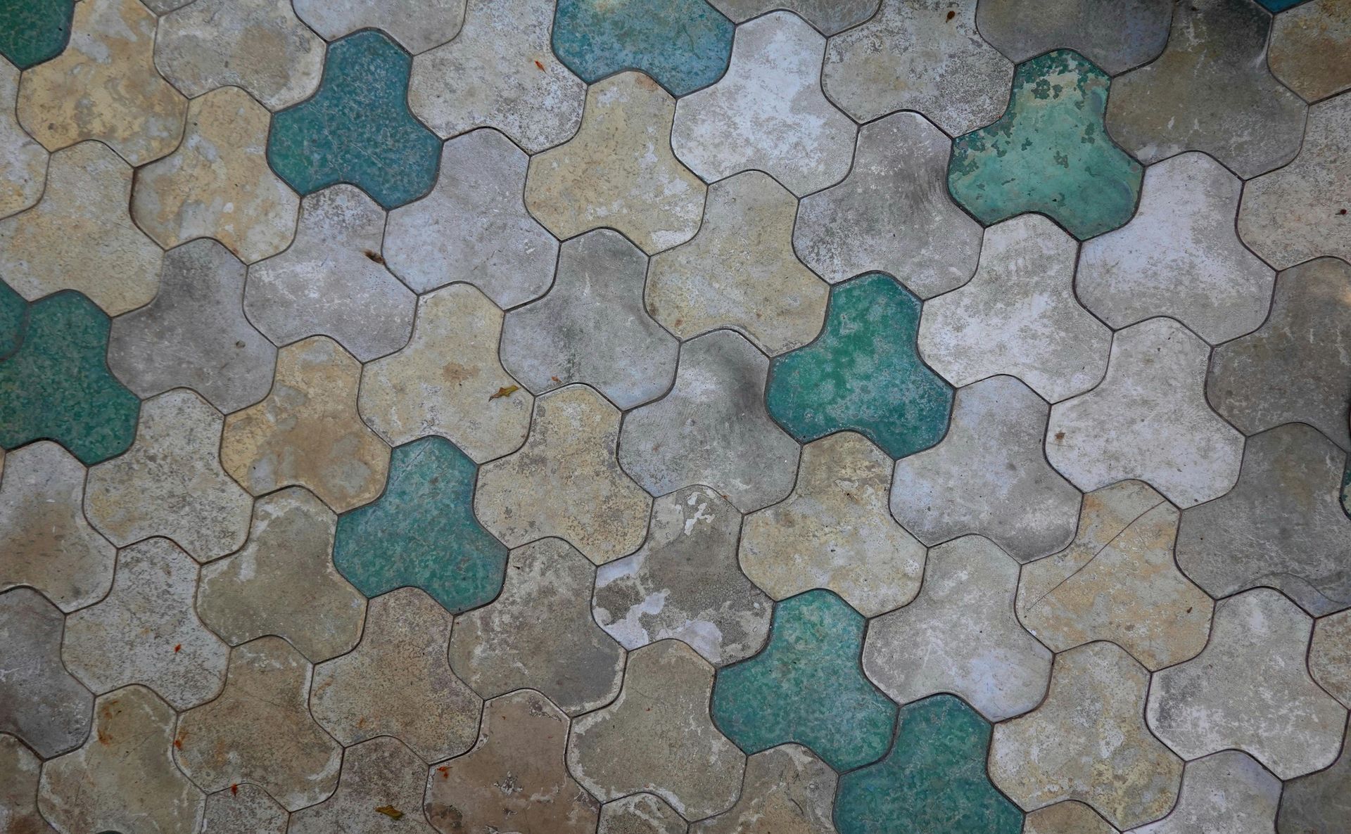 A close up of a tile floor with a pattern of flowers