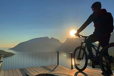 Een fietser kijkt uit over de fjorden in Noorwegen